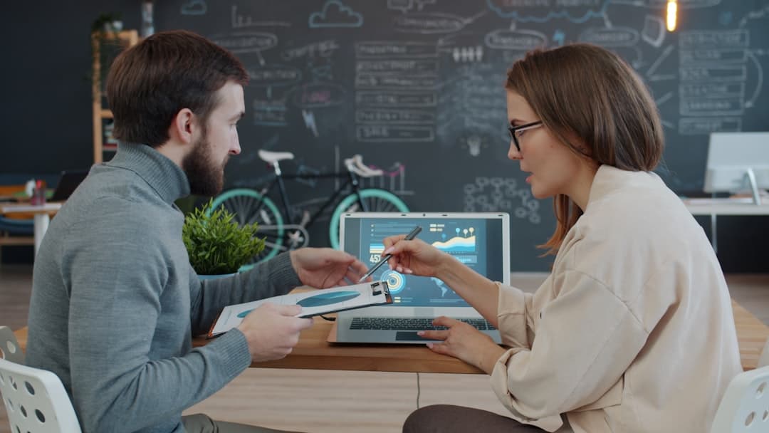 Team reviewing acquisition data and growth metrics on a laptop