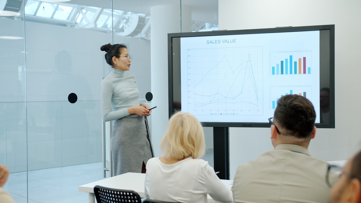 Woman presenting marketing growth data and performance charts to an audience