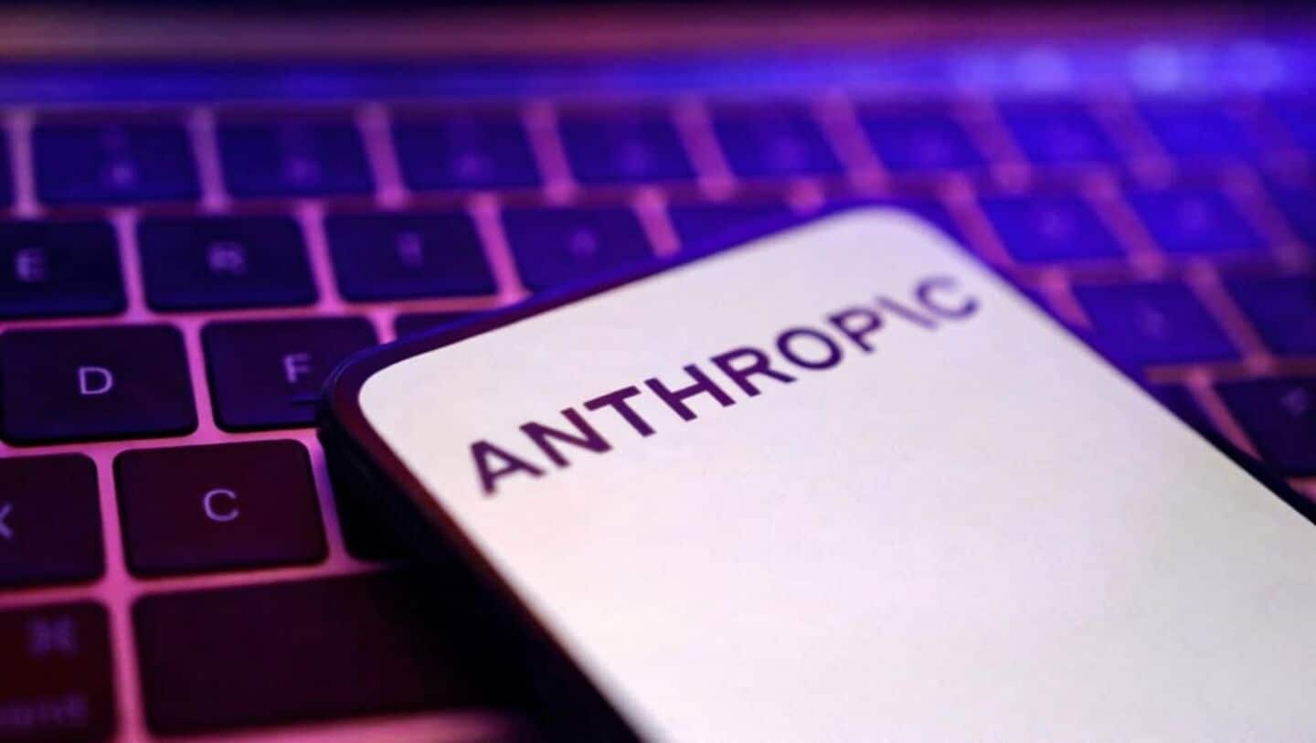 Anthropic logo displayed on a smartphone resting on a laptop keyboard